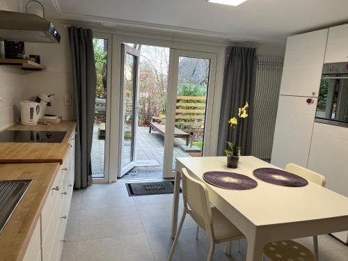 a kitchen with a table with two sinks in it at Studio renové rdc terrasse wépion (Namur) in Namur