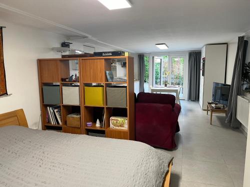 a bedroom with a bed and a book shelf at Studio renové rdc terrasse wépion (Namur) in Namur