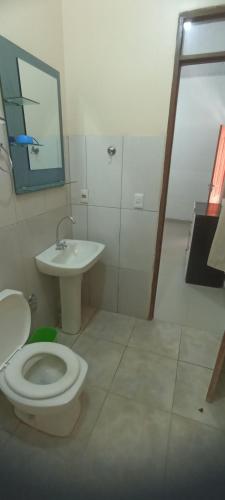 a bathroom with a toilet and a sink at Hotel Cedrillos in Cobija