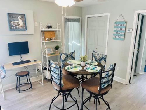 a dining room with a table and chairs and a computer at Beach House in Oceanlakes Campgrounds Myrtle Beach, South Carolina in Myrtle Beach
