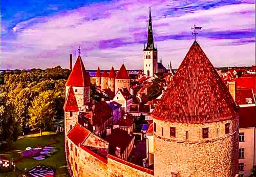 a castle with red roofs and a town with a church at Medieval unit with sauna in Tallinn