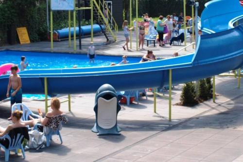a group of people at a water park with a boat at Blissful in Hoenderloo