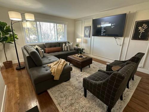 a living room with a couch and a tv at Cozy Mountain Escape in Salt Lake City