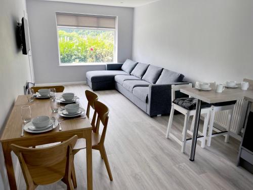 a living room with a table and a couch at Smithdown Rooms in Liverpool