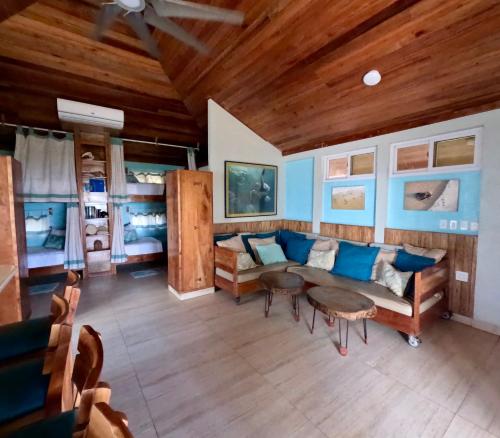 a living room with a couch and a table at Turtles Nest Bunkhouse at Lodge at Long Bay in Corn Islands