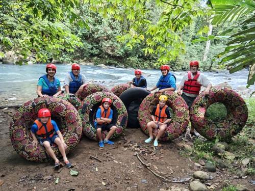 a group of people sitting on inflatable balls on a river at Río Celeste, Cacahua Lodge in Rio Celeste