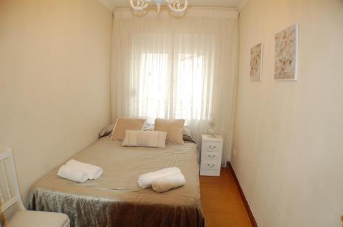 a bedroom with a bed with two pillows on it at Apartamento La Luz de Reinosa 1 in Reinosa