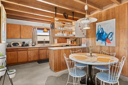a kitchen with a table and chairs in a room at Casa de La Rosa in Santa Fe NM in Santa Fe