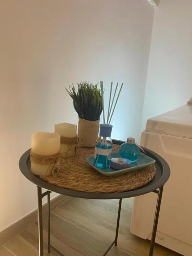 a table with a tray with soap and candles on it at Le Dimore del Portico in Fasano