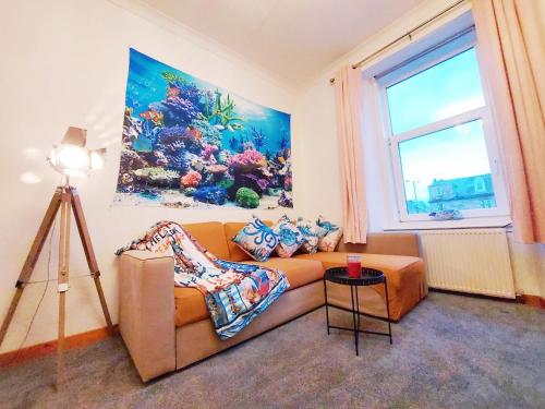 a living room with a couch and a window at The Octopus - at Largs Town Centre with Private Parking in Largs