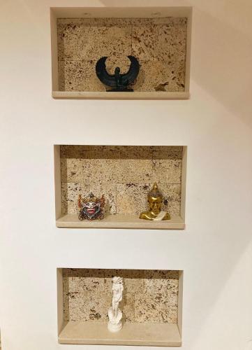 two pictures of objects on a shelf in a wall at Apartment Milos in Belgrade