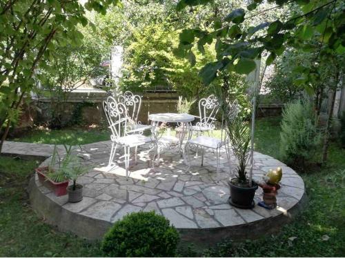 a patio with a table and chairs and a fountain at Apartment Milinković 2 in Kovanluk