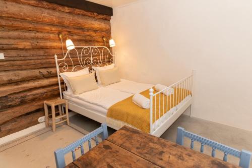 a baby crib in a room with a wooden wall at Loo kodu&köök in Muraste