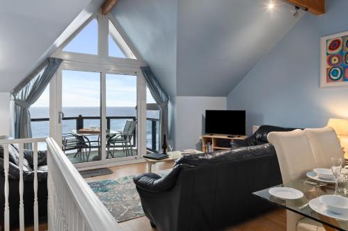 a living room with a view of the ocean at Schooner House - Panoramic Sea Views and Parking in Saundersfoot