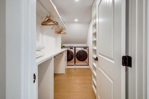 a laundry room with a washer and dryer at Sleek and Modern Cape Cod Home 2 Mi to Beaches! in Hyannis