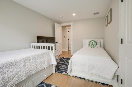 two beds in a bedroom with white walls at Sleek and Modern Cape Cod Home 2 Mi to Beaches! in Hyannis