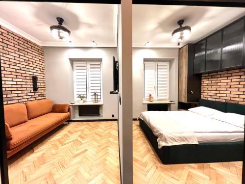 a bedroom with a bed and a couch at AAA STAY Old Town Mariensztat in Warsaw