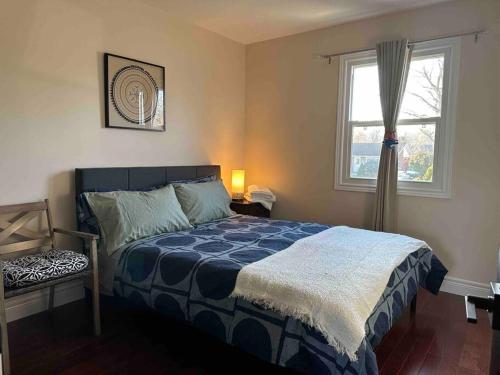a bedroom with a bed and a window at Vacation paradise in St. Catharines