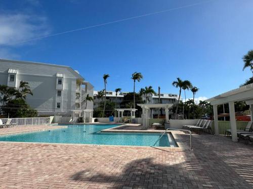 a swimming pool in front of a house at Captiva Bayside Villas 1 Bedroom 2 Bath - sleep 4 in Captiva