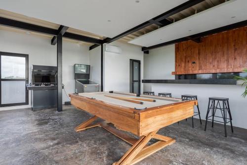 a ping pong table in the middle of a room at Stunning 4br - Rooftop Pool, 5 mins to beach in Tulum