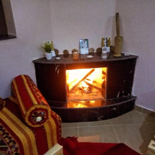 a living room with a fireplace and a couch at Gite Vanadenite in Midelt