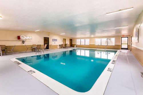 a large swimming pool with blue water in a building at Econo Lodge Inn & Suites in Auburn