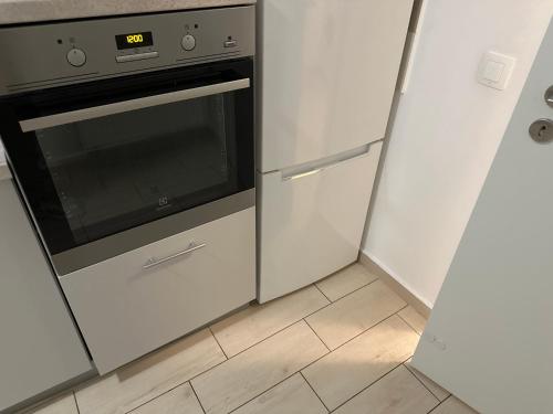 a kitchen with a stove and a refrigerator at Regim hotelier in Braşov