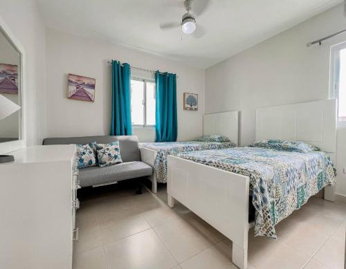 a bedroom with two beds and a chair at Goistay Luxurious Goistay Oasis in Juan Dolio Your Seaside Sanctuary in Punta Cana