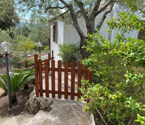 a wooden fence in front of a house at Domo Anghèleda - Alghero casa indipendente vicino al mare in Alghero
