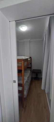 a small room with a bunk bed in it at Ap 154 Balneário Piçarras in Piçarras