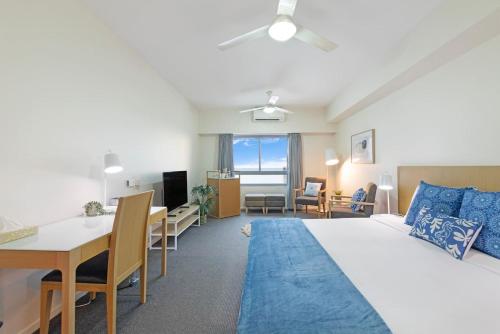 um quarto com uma cama, uma secretária e uma sala de jantar em 'Déjà Blue' Knuckey's King Suite Comfort em Darwin