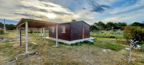a small house sitting on top of a field at Merencere La Esmeralda, Monoambiente a pasos de la playa in La Esmeralda 