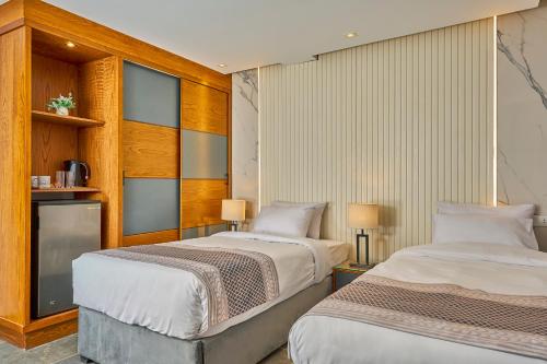 a bedroom with two beds and a fireplace at Khan Duidar Inn - Pyramids View Rooftop in Cairo