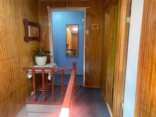 a house hallway with a red slide and a blue door at Hospedaje Sra Jenny in Puerto Montt