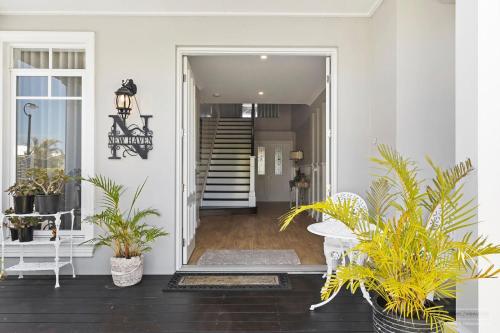 a hallway of a home with potted plants at New Haven - Morning Sunrise Suite in Banksia Beach