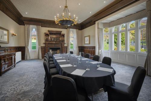 a conference room with a long table and chairs at Delta Hotels by Marriott Breadsall Priory Country Club in Derby
