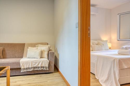 a living room with a bed and a couch at Casa Familia Pestana 2, a Home in Madeira in Seixal