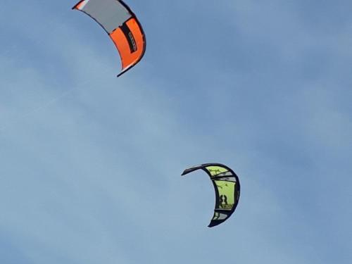 two kites flying in the sky at CHALÉ PORTAL GOSTOSO in São Miguel do Gostoso