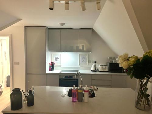 a kitchen with a table and a counter top at The Penthouse Double Bedroom for Rent Free Parking in Epsom