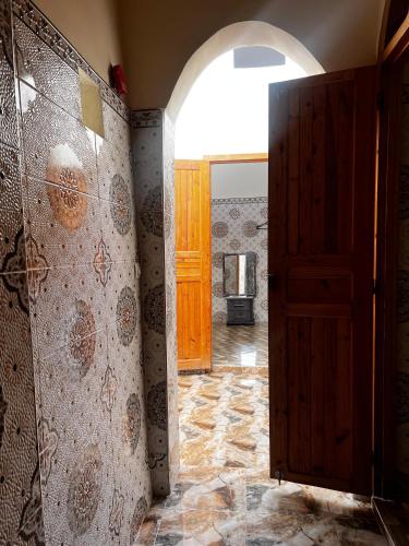 a hallway with an open door in a house at Dar Lala Haniya in Rabat