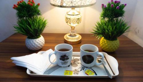 two cups of coffee on a tray on a table at Hotel Muna International (Second Floor) in Dhaka