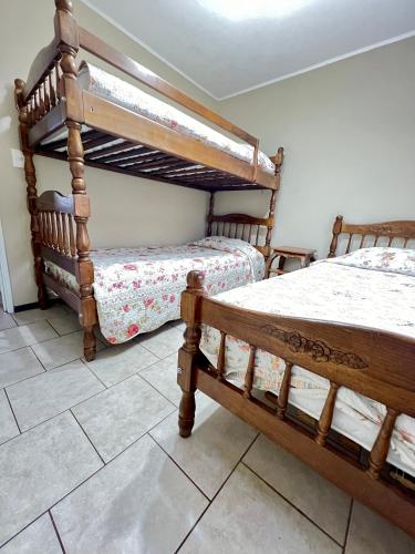 a bedroom with two bunk beds and a tile floor at Casa en Pucón in Pucón