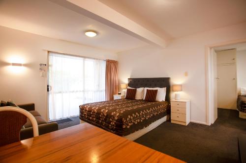 a hotel room with a bed and a window at Casino Court Motor Lodge in Christchurch