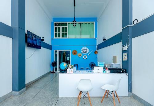 an office with blue walls and white chairs at iTalay Krabi in Ban Suan