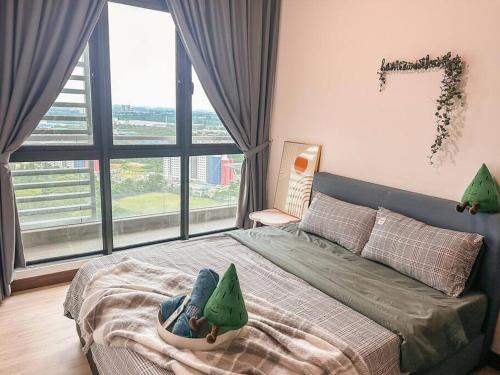 a person laying on a bed in a bedroom at [Starry x GREEN @GreenHaven]3Beds2Bath in Masai