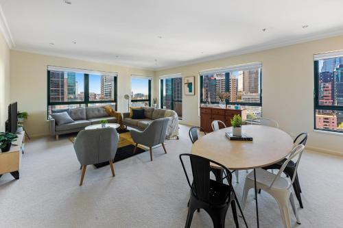 a living room with a couch and a table and chairs at Regency Towers in Melbourne