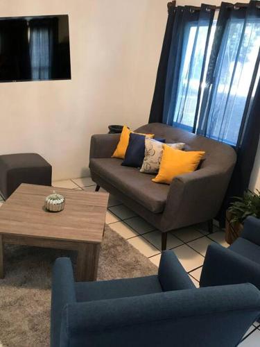 a living room with a couch and a coffee table at Posadas nido del tecolote in Guadalajara