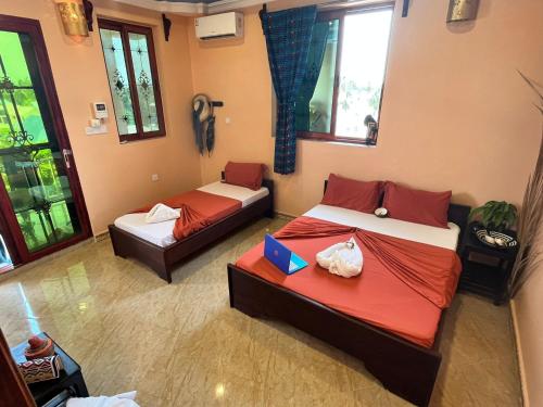 a bedroom with two beds and a couch at Stardust Villa - ** Hotel in Paje