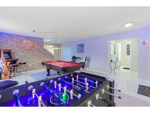 a room with a pool table and a ping pong ball at Themed 6BD Home with Pool - Near Orlando Attractions in Kissimmee