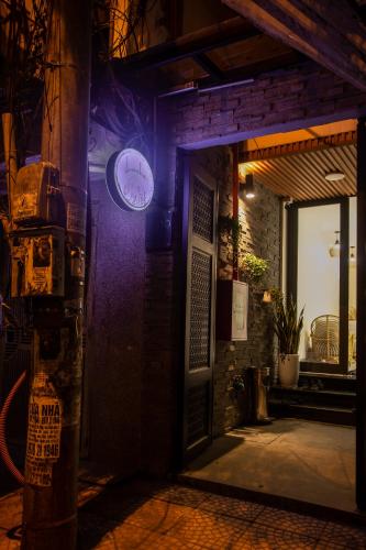 a door with a clock on the side of a building at Lanha Hotel - Homestay in Hanoi
